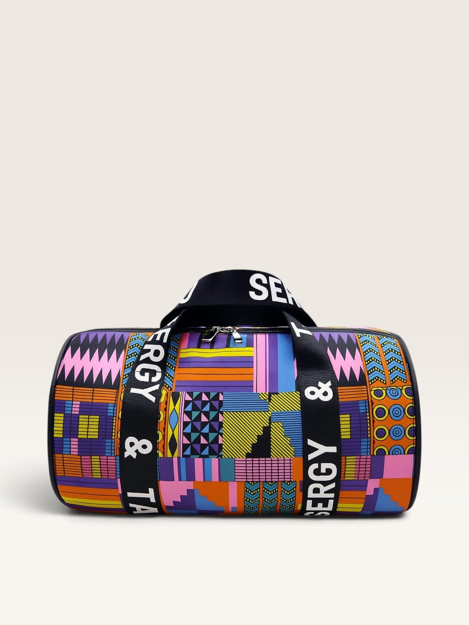 Bolso tipo macuto Sergy & Tapiju de lona con estampado geométrico colorido, ribetes de cuero y asas serigrafiadas.